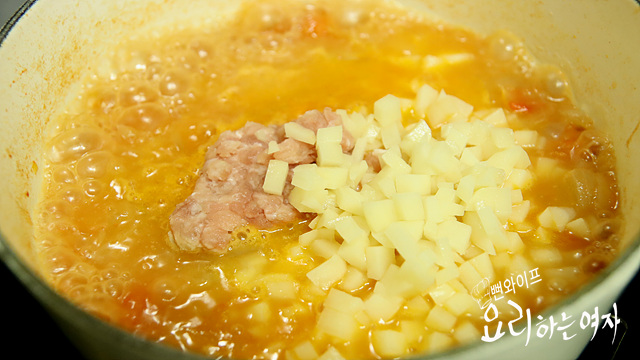 Add meat and potatoes, then simmer — step photo 1