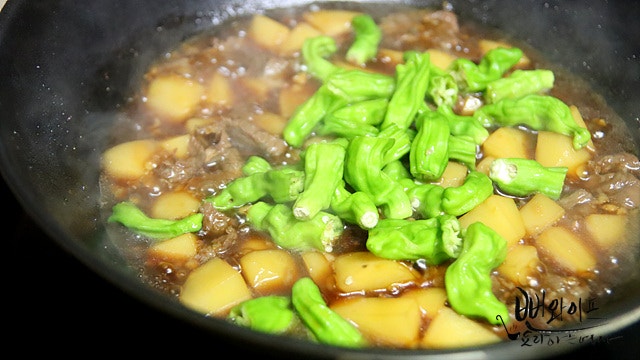 Add shishito peppers and braise down — step photo 1