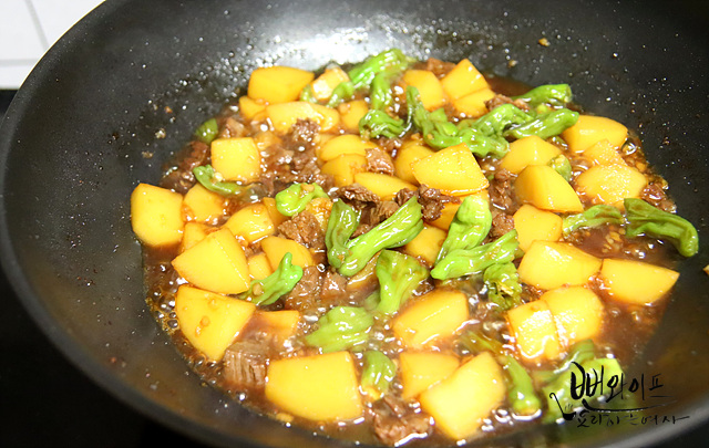 Add shishito peppers and braise down — step photo 2