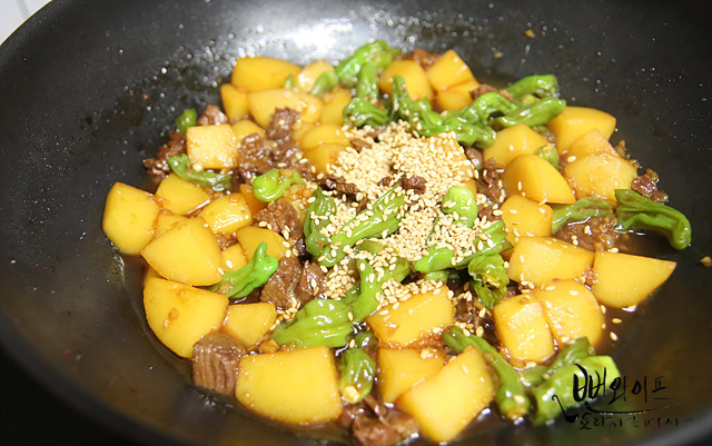 Add shishito peppers and braise down — step photo