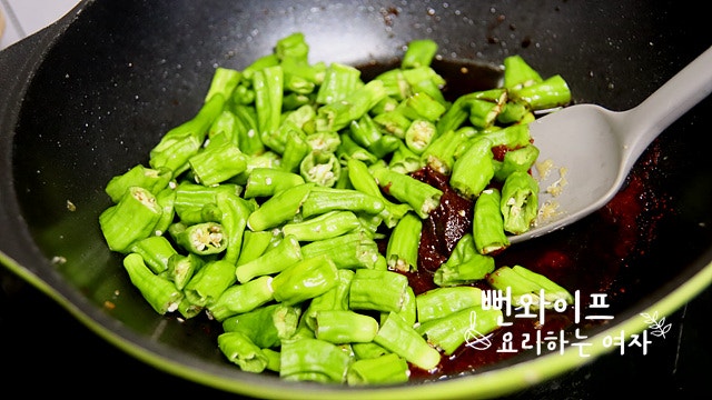 Simmer the shishito peppers in the sauce — step photo 2