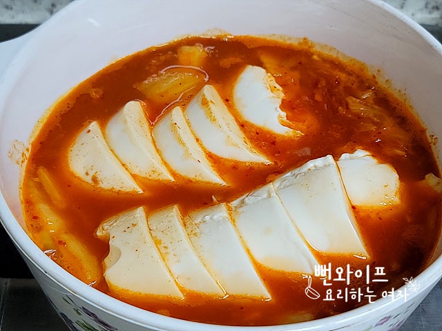 Add soft tofu and simmer — step photo 2