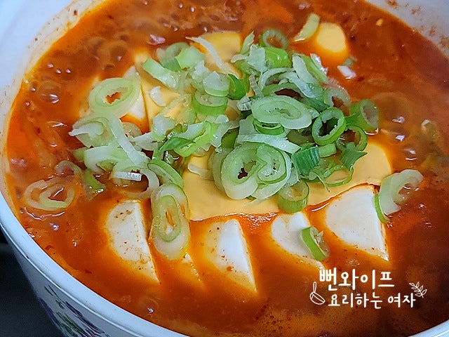 Add soft tofu and simmer — step photo 2